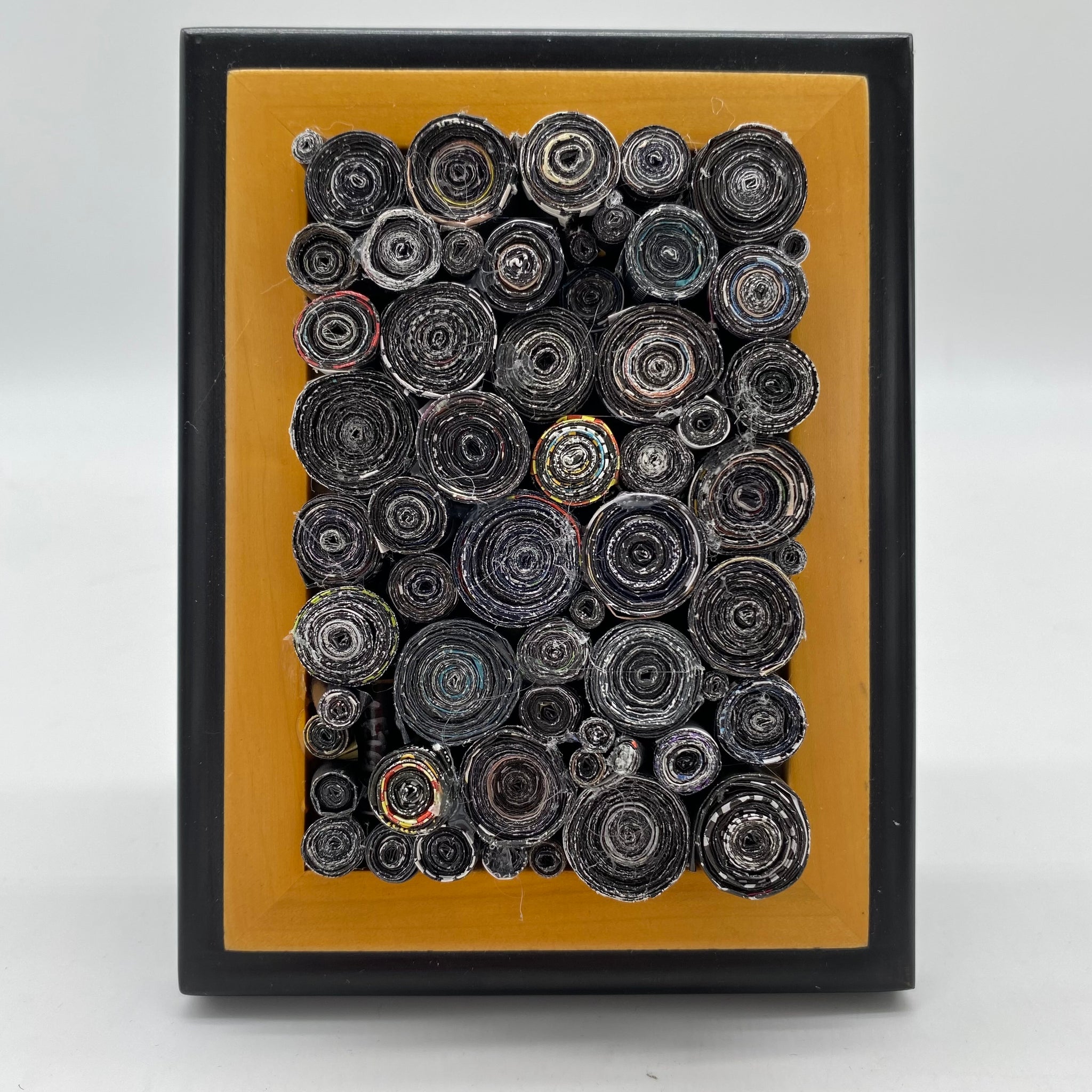 Rolled black rolled magazines created by Trash Art Treasures